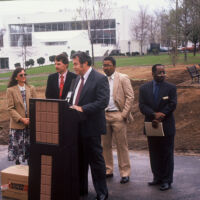 Atlanta Groundbreaking 1992 men in suits are speaking in a booth