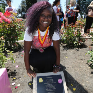Stockton An African-American girls next to a dedication plaque