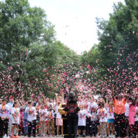 Atlanta Celebration 2017 many people in bright and white clothes are throwing petals in the air