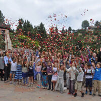 Lake Shrine Rose Toss 2017 People are tossing rose petals in the air