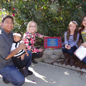 Southport School Family gathered around a plaque