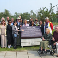 Jinan, China Garden Plaque 2010 men and women smiling around a garden plaque