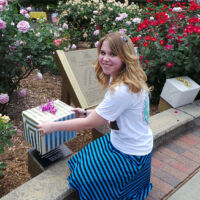Atlanta Girl revealing a plaque