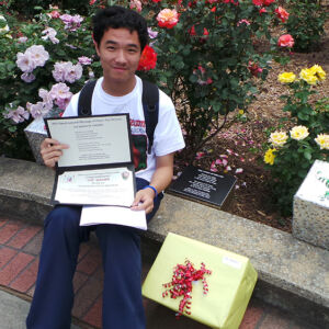 Atlanta Jinan Student a Chinese student holding certificates of a plaque
