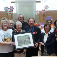 Presentation of Plaque & Roses to Jewish Community men and women holding a plaque