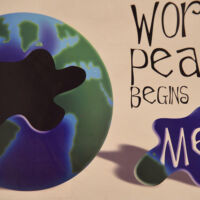 California World Peace begins with me a puzzle made of a side of a graphic earth