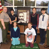 Chinese & Washington DC Winners with MLK Administrators People are gathered around christamas