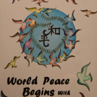 Elk Grove California World peace begins with me, many different colored doves flying out of blue cirlce