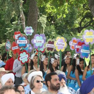 Planting of Qualities of Peace 2013 People holding flowers with peace messages