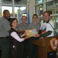 Special gift from MLK Administrators MLK 25th Anniversary 2017 People holding a special gift and smiling