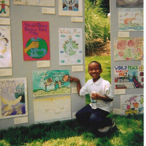 State Capitol-Artist Admiring his artwork An African- American Boy showing his artwork on an art display