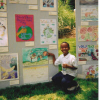 State Capitol-Artist Admiring his artwork An African- American Boy showing his artwork on an art display